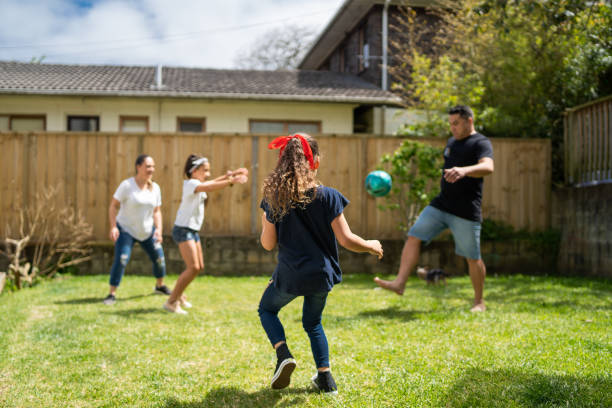 Family well-being. Playing soccer in backyard in Auckland, New Zealand. auckland region photos stock pictures, royalty-free photos & images