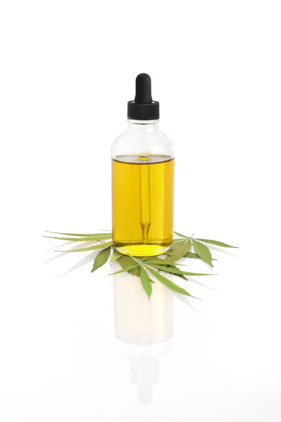 Bottle of CBD Oil with hemp leaf Close-up of Bottle of CBD Oil with hemp leaf on white background tincture stock pictures, royalty-free photos & images