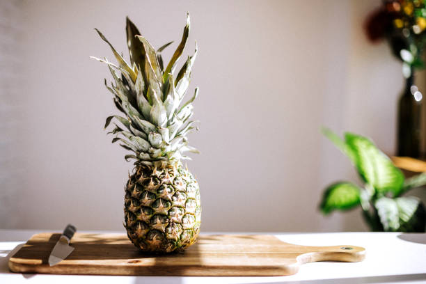 Juicy pineapples on cutting board