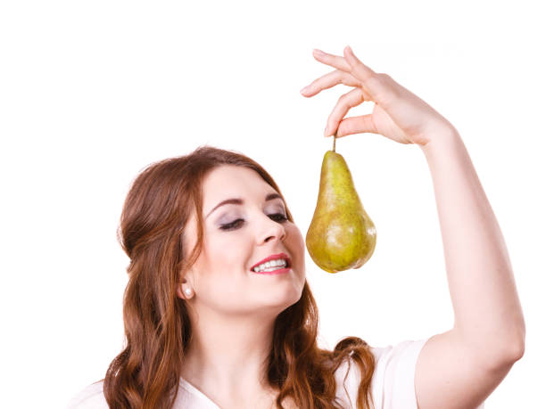 Woman holding pear fruit, isolated. Healthy diet.