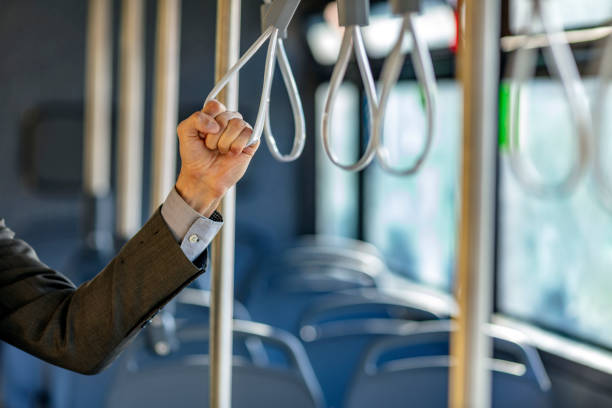 Unrecognizable male Hand holding  strap on public train or bus.