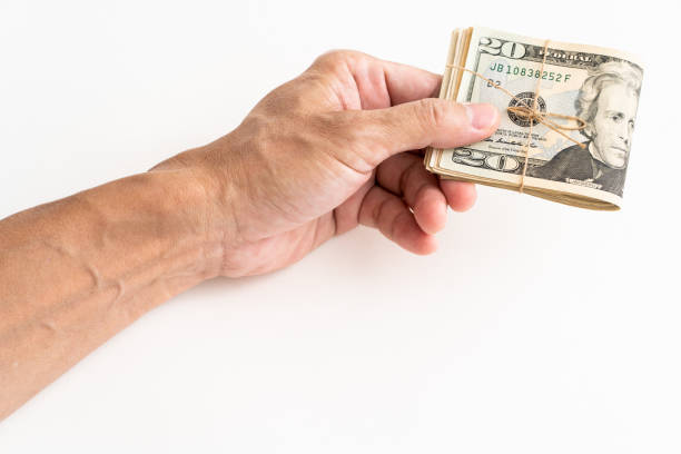 istock Hand holding American dollars banknote on white background 1185315752
