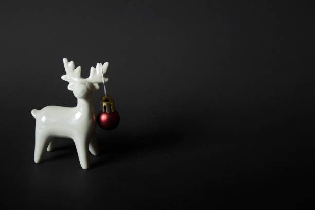 istock White porcelain reindeer on black background 1185315866