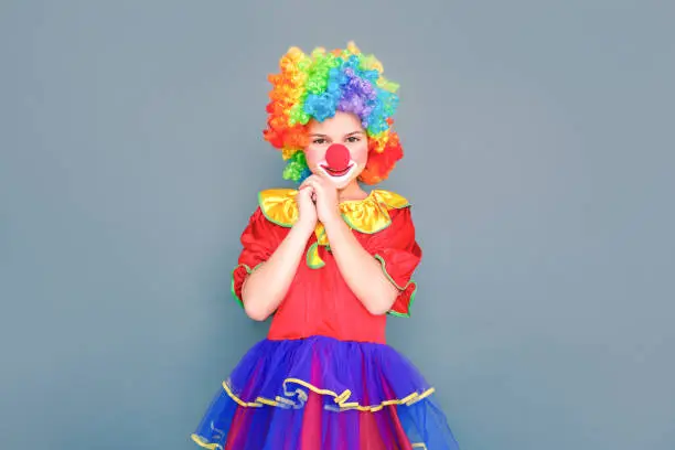 Photo of Happiness little girl in clown suit looking at camera