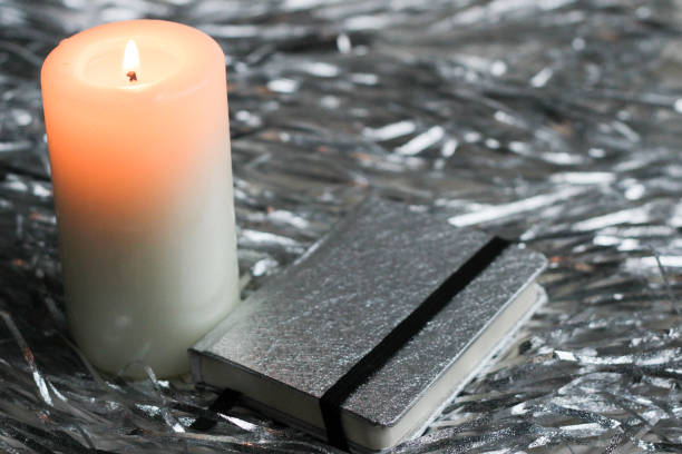 istock a white candle stands on a grey background with festive decorations (Christmas, new year) 1185319761