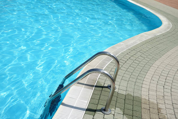 istock Ladder in crystal clear blue swimming pool 1185321601