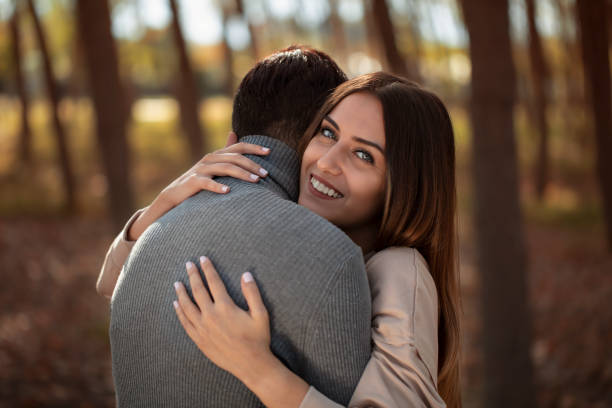 istock young lovers hugging each other smiling - stock Image 1185322460