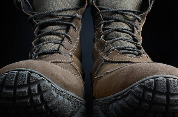 istock Brown suede military tactical boots standing. 1185322565