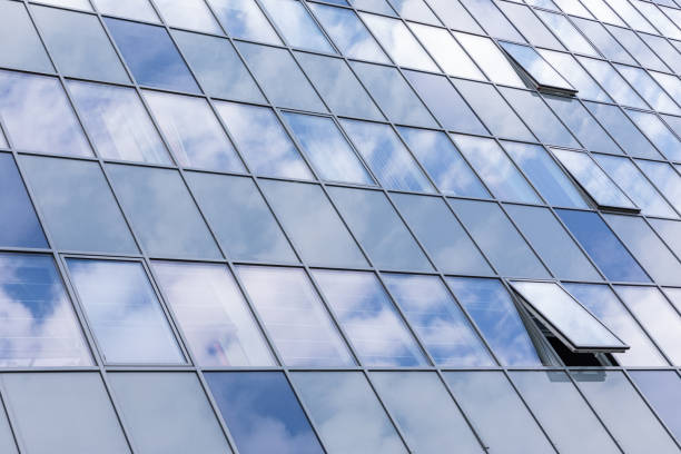 istock Close-up of modern, just-build building with sky reflection on facade. 1185324292