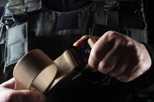 istock Soldier in black armor tactical vest standing with belt. 1185324480