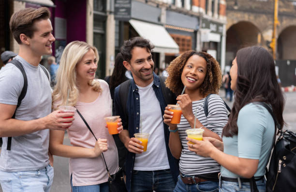 istock Happy group of friends outdoors drinking smoothies and talking 1185326206