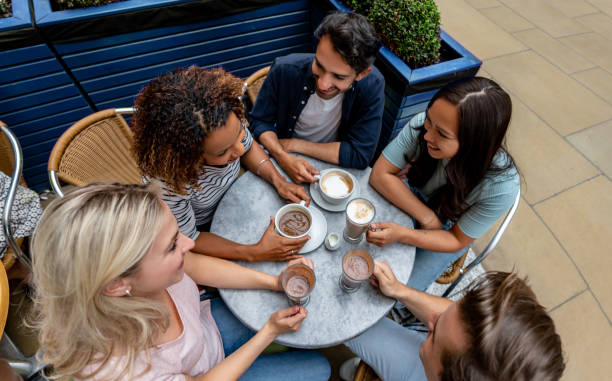 istock Happy group of people talking at a cafe 1185326242