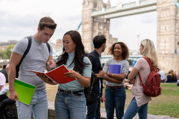 istock Happy students studying outdoors in London 1185326261