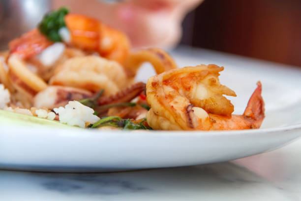 istock Stir fried shrimp with basil on white dish 1185327675
