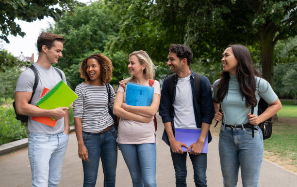 istock Multi-ethnic group of students at the park looking happy 1185328703