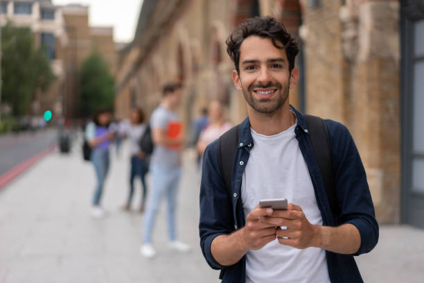 istock Happy man texting on his cell phone 1185328736