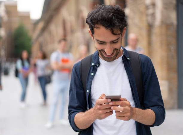 istock Happy man social networking  on his cell phone 1185328738