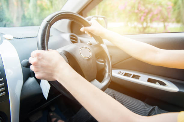 istock Driver hands holding steering wheel for control car. 1185329769