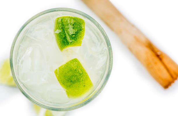 Caipirinha isolated on white background (selective focus; close-up shot)