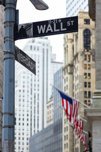 wall street sign with flags stock photo