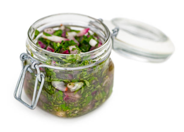 istock Some Homemade Chimichurri isolated on white (selective focus) 1185335490