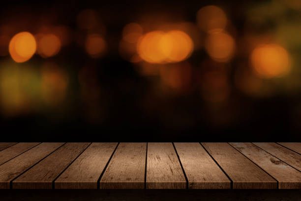 istock Wooden table with a view of blurred beverages bar backdrop. Blur cafe and restaurant with abstract bokeh light background. For create montage product display 1185335564