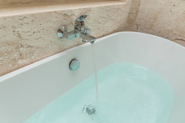 istock Luxury bath tub and faucet with water 1185336654