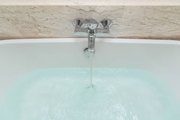 istock Luxury bath tub and faucet with water 1185337190