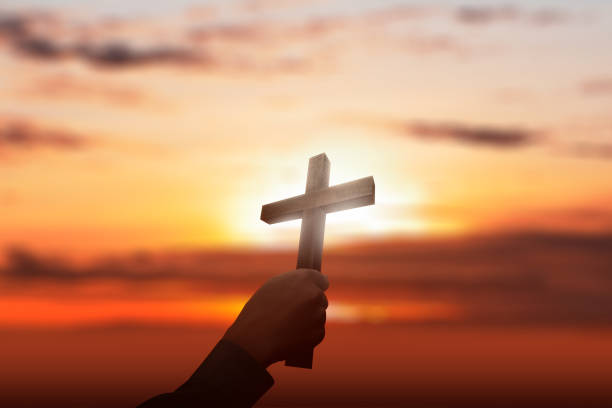 istock Human hand holding Christian cross 1185337719