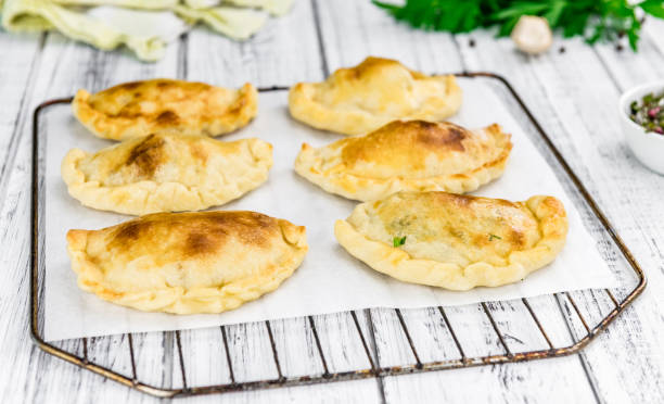 istock Some Empanadas on a vintage wooden table (selective focus; close-up shot) 1185339497
