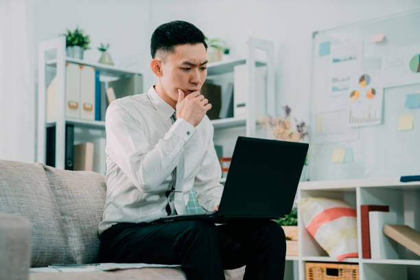 istock Young man working absorbed on laptop 1185343172