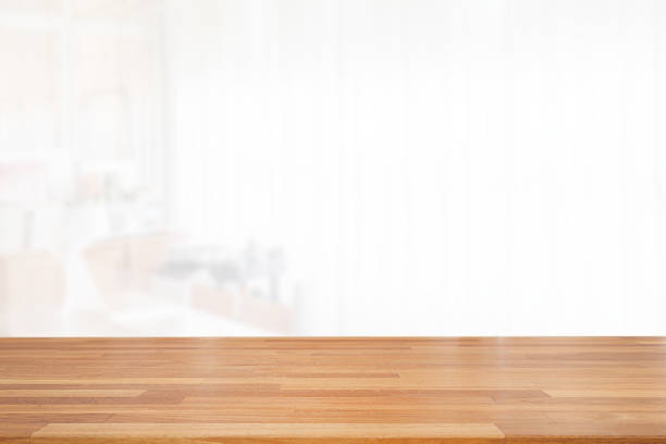 istock Beautiful empty wood table top on white clear indoor room background with curtain. copy space. Ready for product montage advertise 1185345105