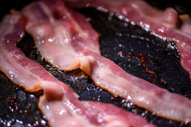 istock Bacon slice being cooked on a frying pan. Close up 1185347274