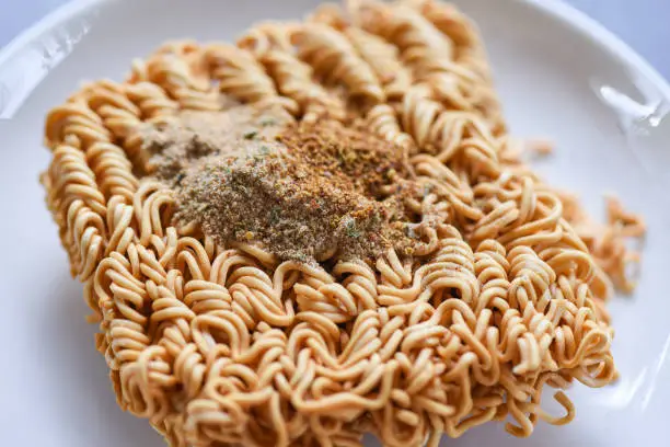 instant noodles on bowl with seasonings monosodium glutamate / Noodle thai junk food or fast food diet unhealthy eat msg concept , selective focus