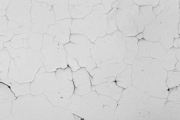 istock Cracked flaking white paint on the wall, background texture 1185353454