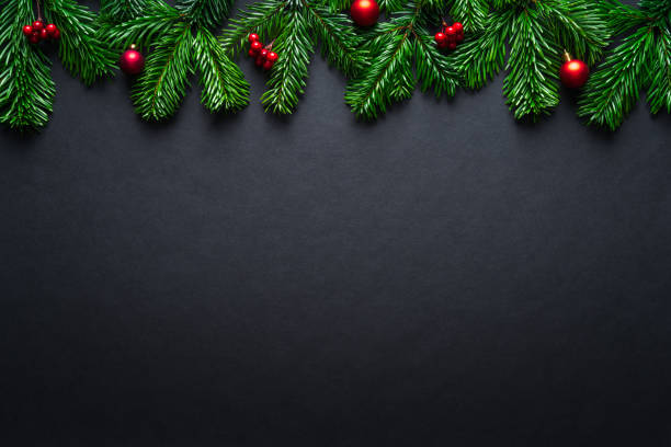 istock Black Christmas border with fir branches and baubles 1185353535