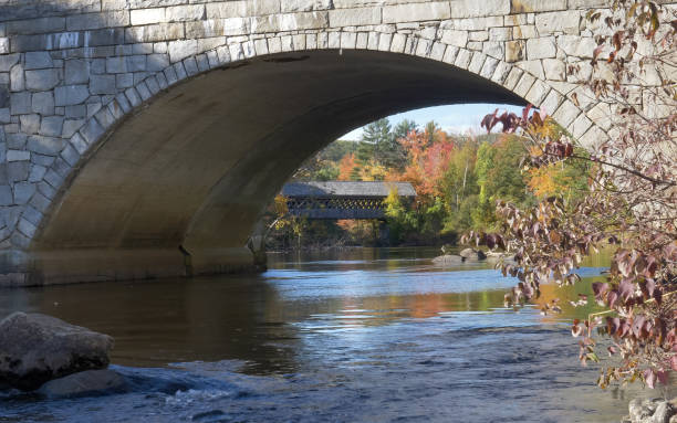 istock henniker covered bridge in new hampshire with trees in fall thru archway 1185353599