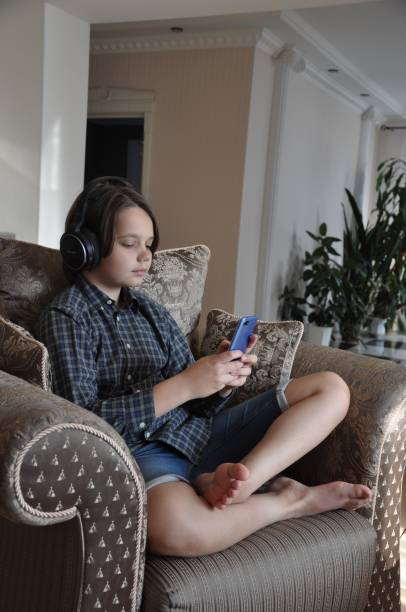 istock Boy from Belarus is using his Smart Phone Indoors. 1185356860