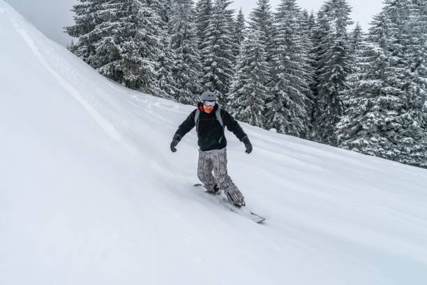 istock Snowboarder rides from powder snow hill. Mountain freeride snowboarding. Winter Carpathians 1185361237