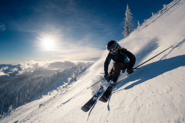 powder turns female skier on ski slope alpine skiing stock pictures, royalty-free photos & images