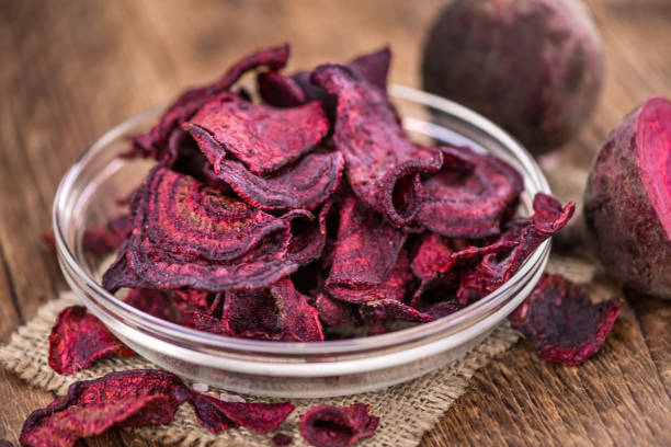 istock Portion of healthy Beetroot Chips on an old wooden table (selective focus; close-up shot) 1185364423