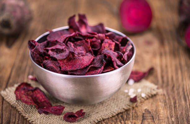 istock Portion of healthy Beetroot Chips on an old wooden table (selective focus; close-up shot) 1185364460