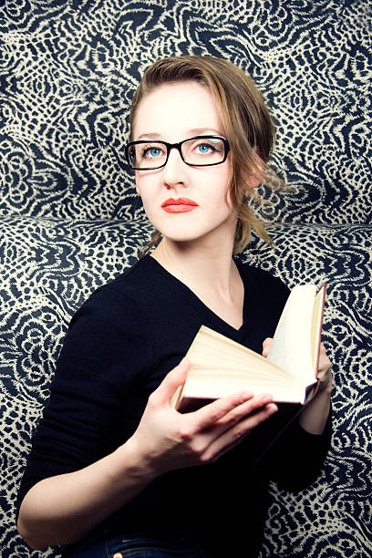 istock young beautiful woman in glasses with  book 118536509