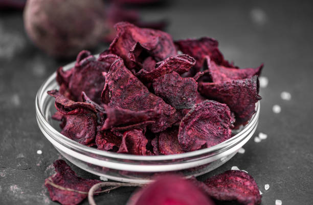 istock Portion of fresh made Beetroot Chips on a slate slab (selective focus) 1185365304