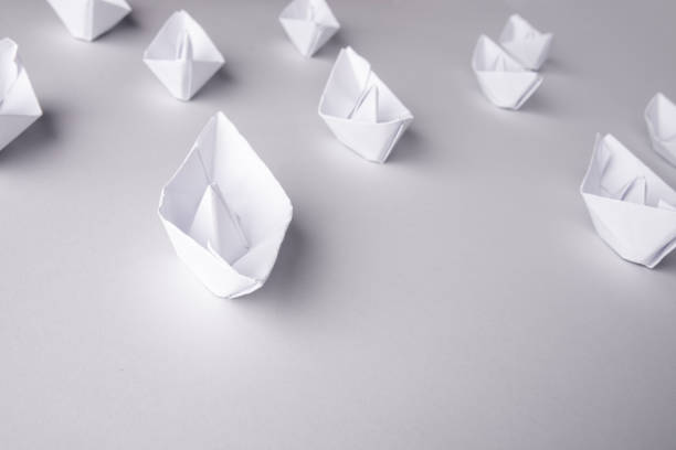 istock paper ships on a white background. Place for text 1185365377