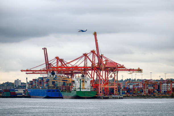 istock International cargo ship with containers cargo cranes and helicopter flying 1185368973