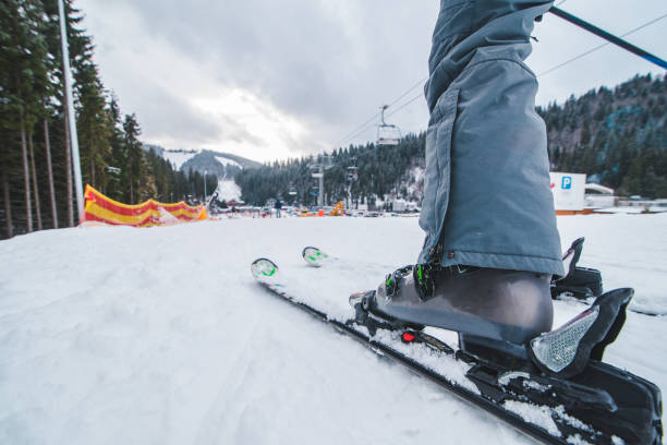 istock leg with ski close up. winter time.snowed vacation. 1185370733