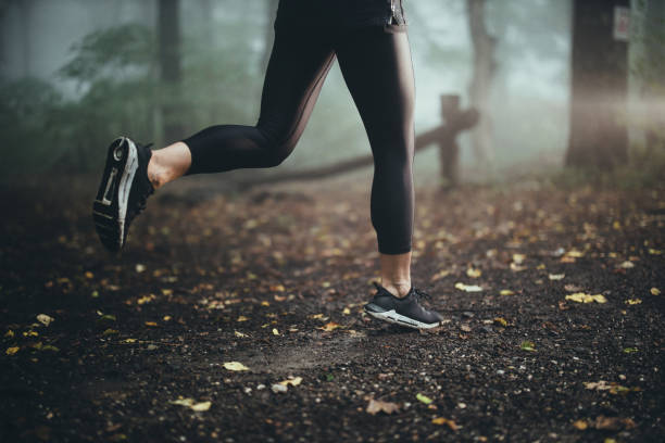 istock Unrecognizable athlete running during bad weather conditions. 1185371701