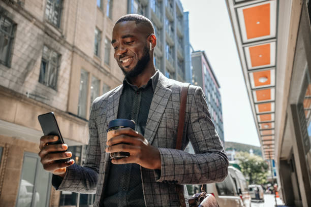 istock African Businessman Text Messaging And Holding A Cup Of Coffee 1185371902