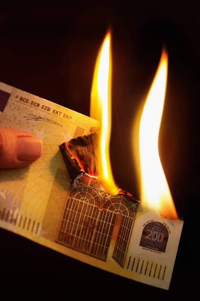 istock Hand holds a burning 200 Euro banknote 1185372898